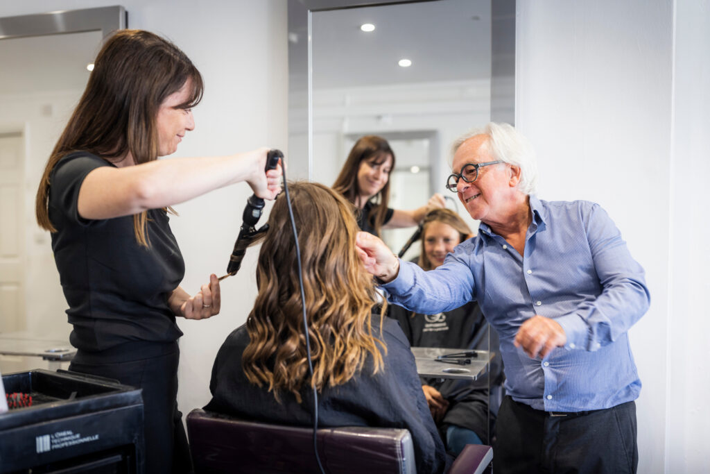 (c) Christopher Ison Photography – ISON_230705_Expressions_7610 A customer getting their haircut by two staff members at Expressions Hair hairdresser in Midhurst, West Sussex.