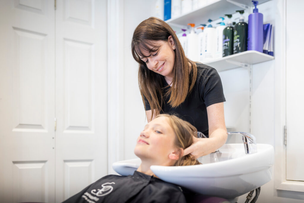 (c) Christopher Ison Photography – ISON_230705_Expressions_7703 A client getting their hair washed by a staff member at Expressions Hair hairdresser in Midhurst, West Sussex.