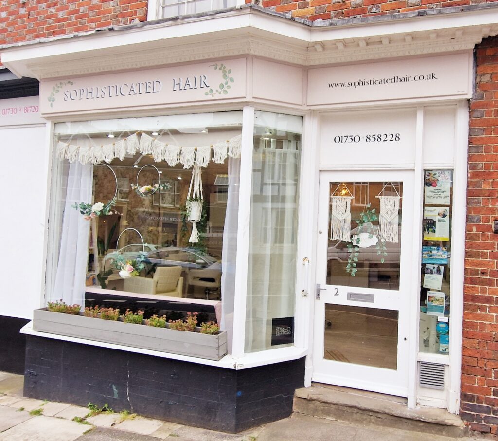 (c) Sophisticated Hair – 20240902_155342 The pink exterior shop front of Sophisticated hair hairdresser in Midhurst, West Sussex.