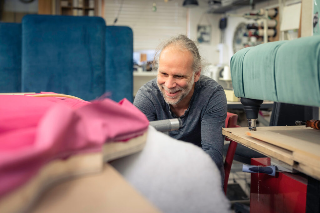 A view of a staff member inside the workshop of The Upholsterer, interior design and upholstery on North Street in Midhurst, Sussex.