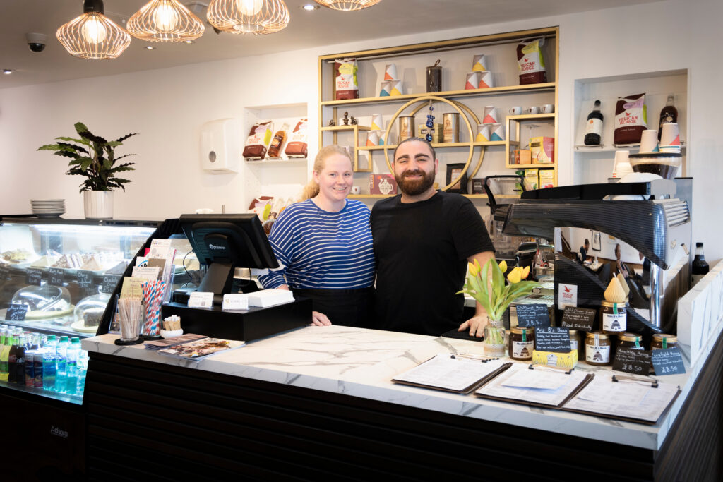 (c) Christopher Ison Photography – Kemaelli’s Midhurst interior Ellie and Kemal 2 Staff members Ellie and Kemal of Kemaelli's cafe behind the counter in Midhurst.