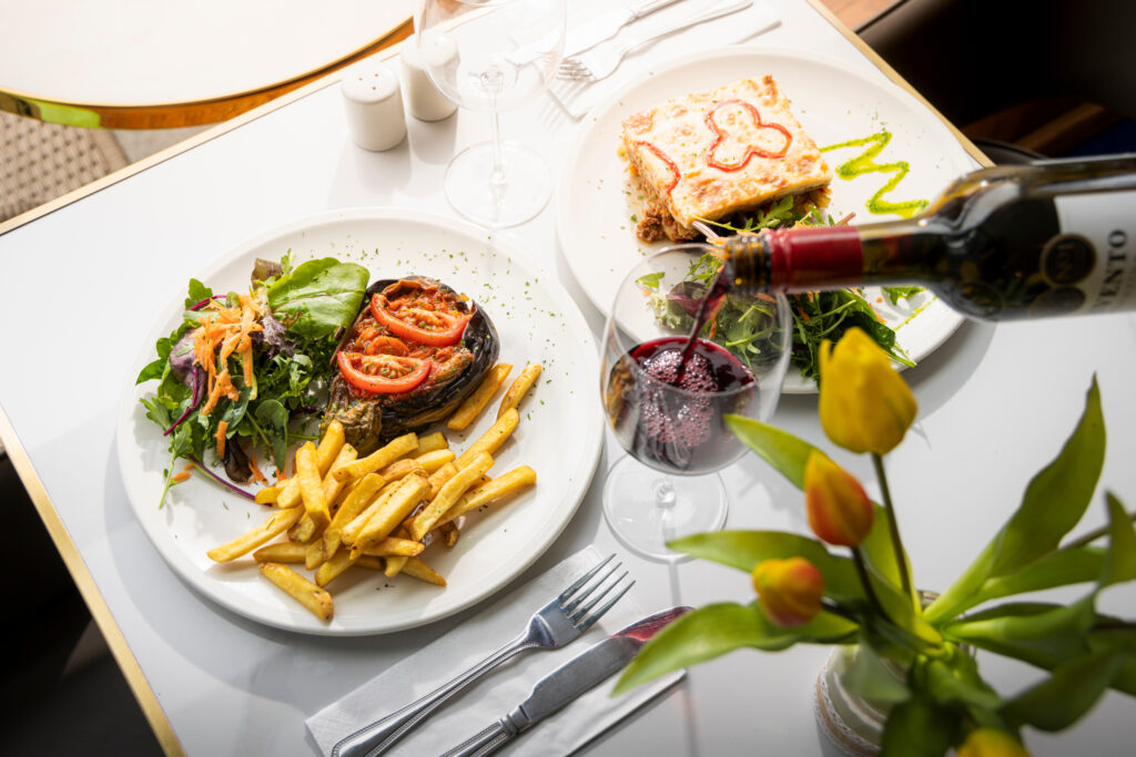 (c) Christopher Ison Photography – Kemaelli’s Midhurst lunch 3 A top down view of a Kemaelli's cafe lunch with a glass of wine on a white table, Midhurst, West Sussex.