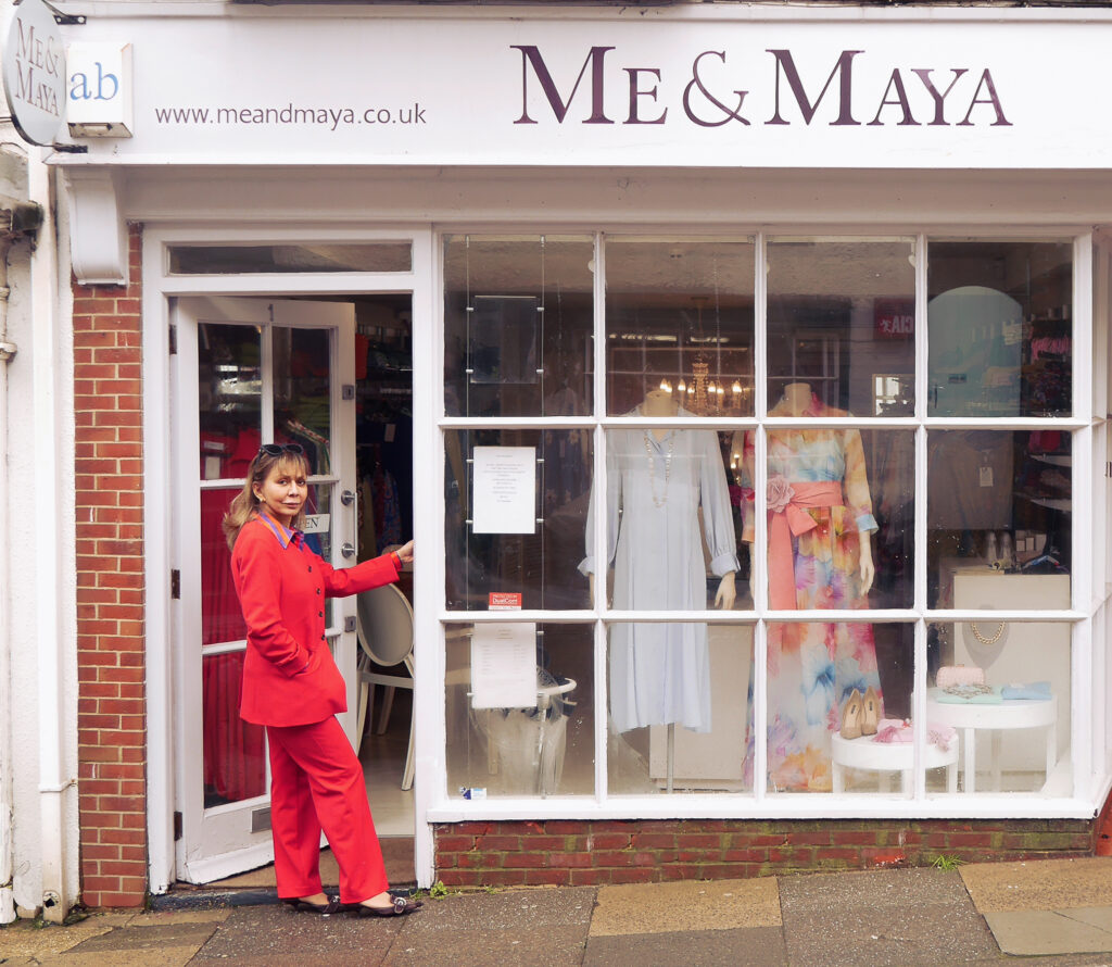 (c) Me & Maya – lalita in front of shop edit A staff member of Me & Maya stood in her shop entrance, Midhurst, West Sussex.