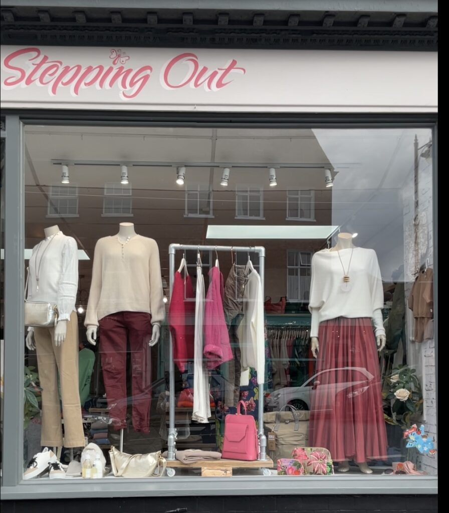 (c) Stepping Out Boutique Midhurst – 1 The exterior of Stepping Out Boutique clothes shop in Midhurst with three clothed mannequins in the window front.