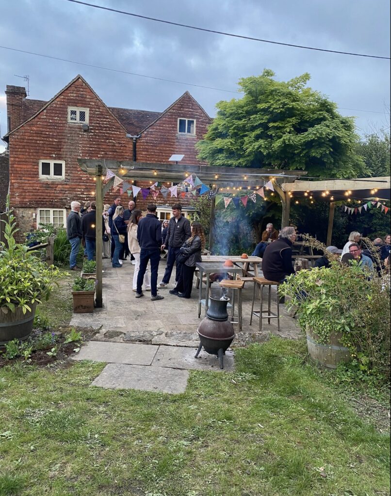 (c) The Hollist Arms – Screenshot 2 The garden of The Hollist Arms pub in West Sussex with many pub goers.