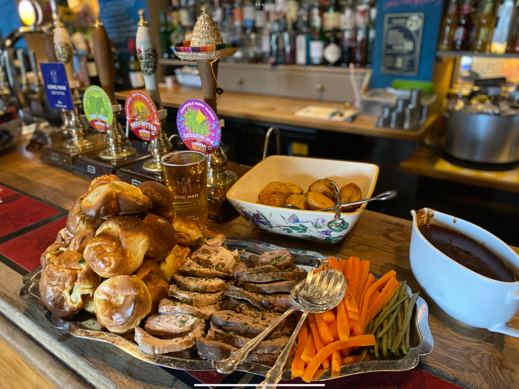 (c) The Hollist Arms – IMG_7478 A silver tray filled with food for a Sunday roast on the bar counter at The Hollist Arms pub in West Sussex.