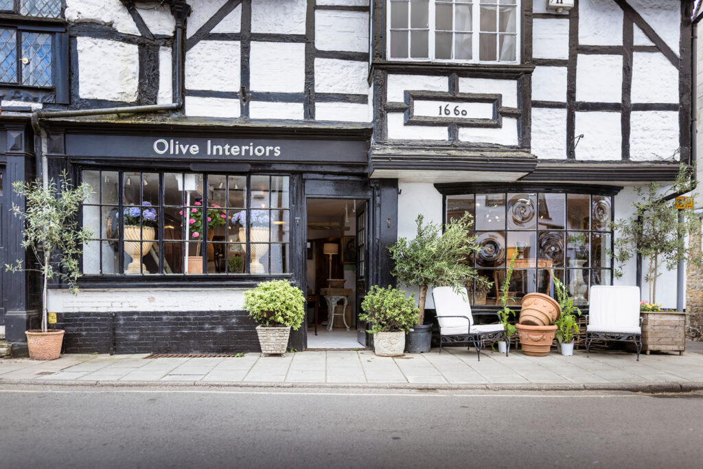 (c) Christopher Ison Photography – ISON_230624_OliveInt_3766 Exterior of Olive Interiors in West Street Midhurst with furniture and plants outside.