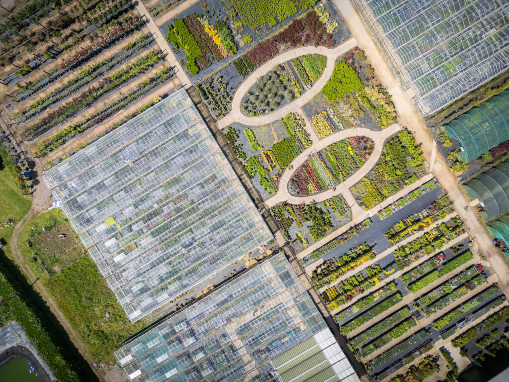 (c) Christopher Ison Photography – ISON_240516_RNGC_0016 An aerial view of Rotherhill Nurseries and Garden Centre in Midhurst, West Sussex showing a vibrant range of plants and large greenhouses.