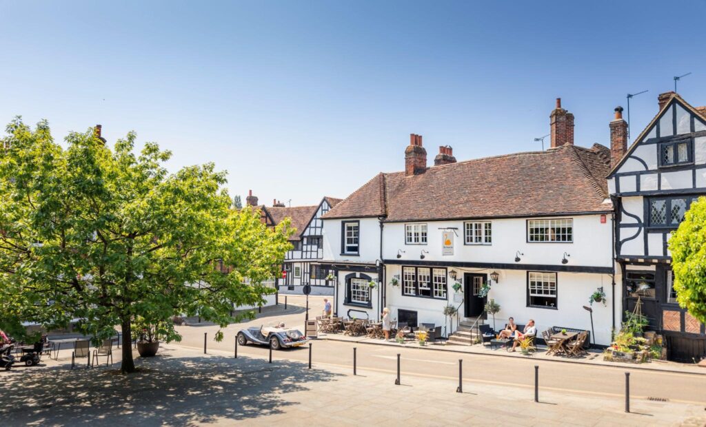 Midhurst Town Square and exterior of The Swan Inn on a summers day.