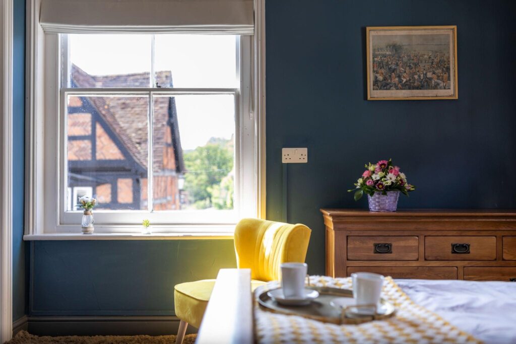 Inside a room at The Swann Inn in Midhurst, looking out to the street on a sunny day.